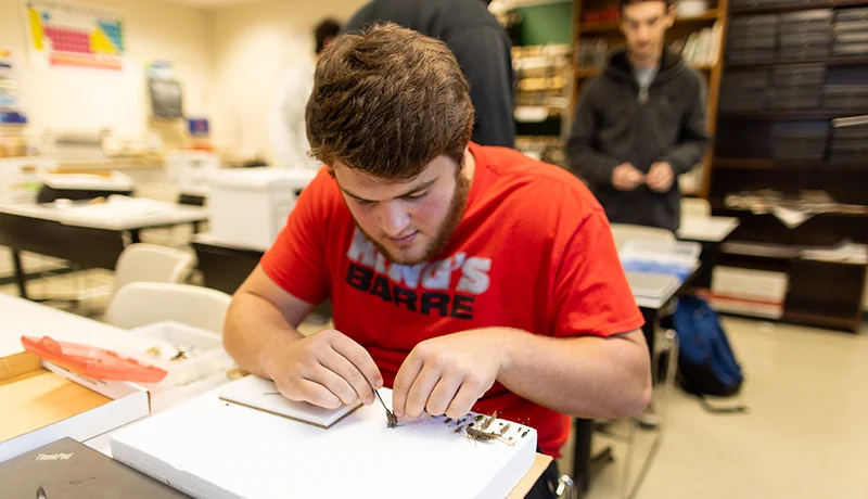 environmental science degree student studying out of a textbook