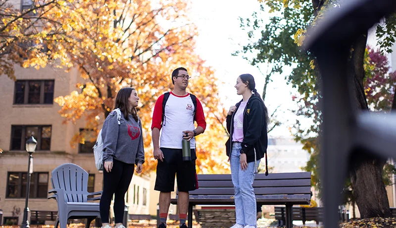 history degree students standing outdoors talking