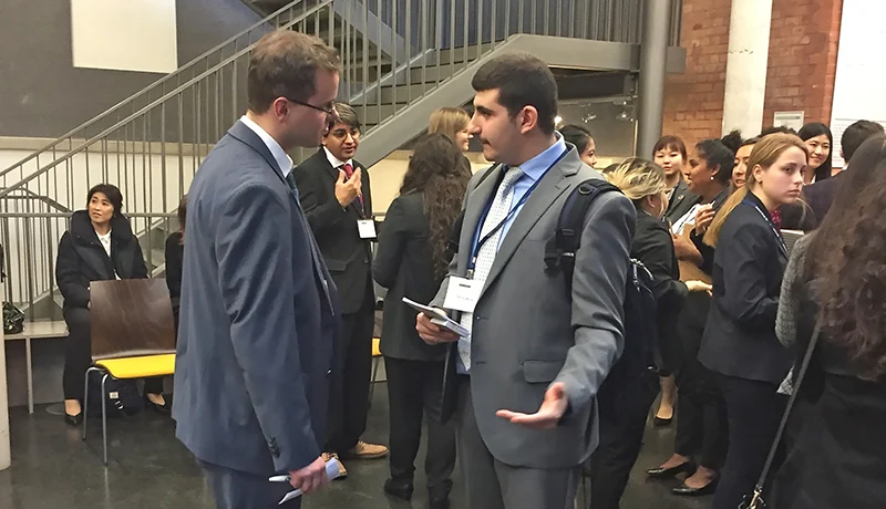 international relations students in suits meeting in a business setting