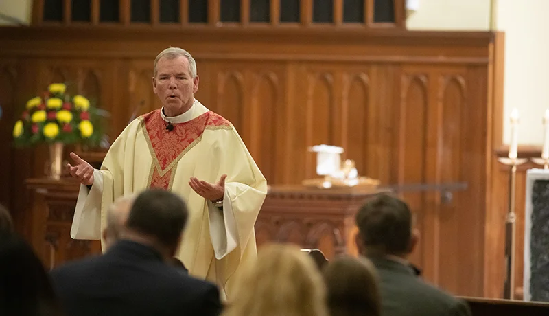 father looney conducting mass in the chapel