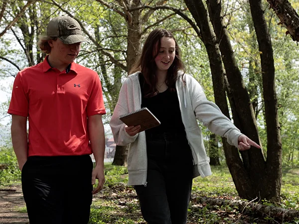 sustainability studies students in a forest