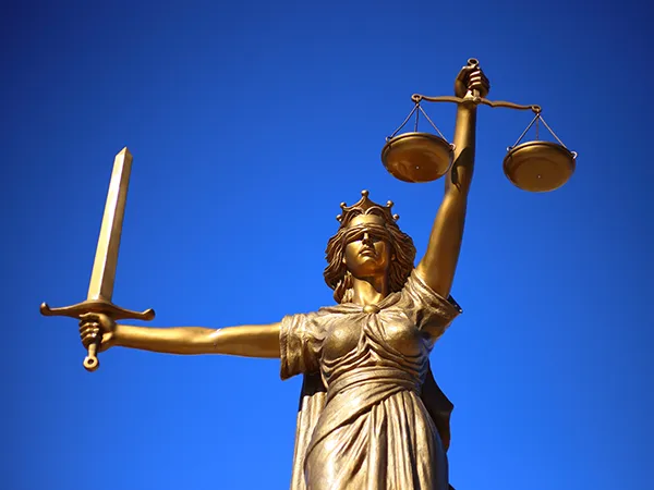 a statue holding a scale and sword, a symbol associated with law and the political science major