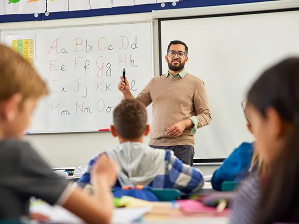 a professor teaching a class in an education classroom, an example of what you can do after an online reading specialist masters program