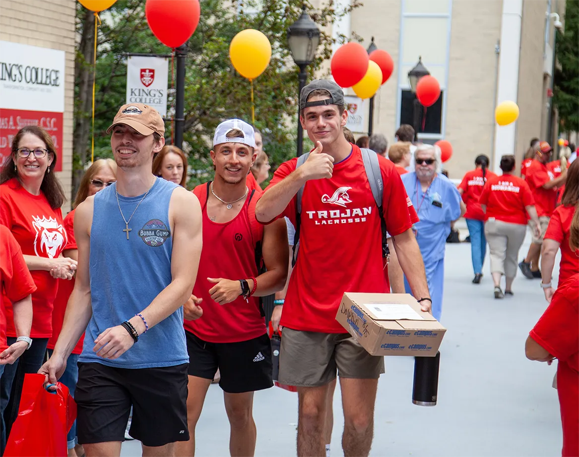 students process under balloons during orientation