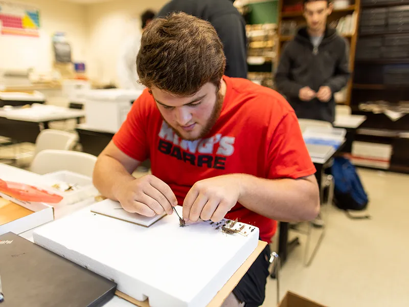 student taking a test in a classroom