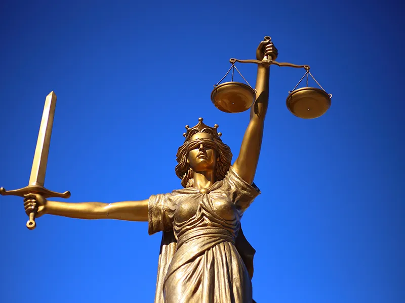 statue holding a sword and a scale